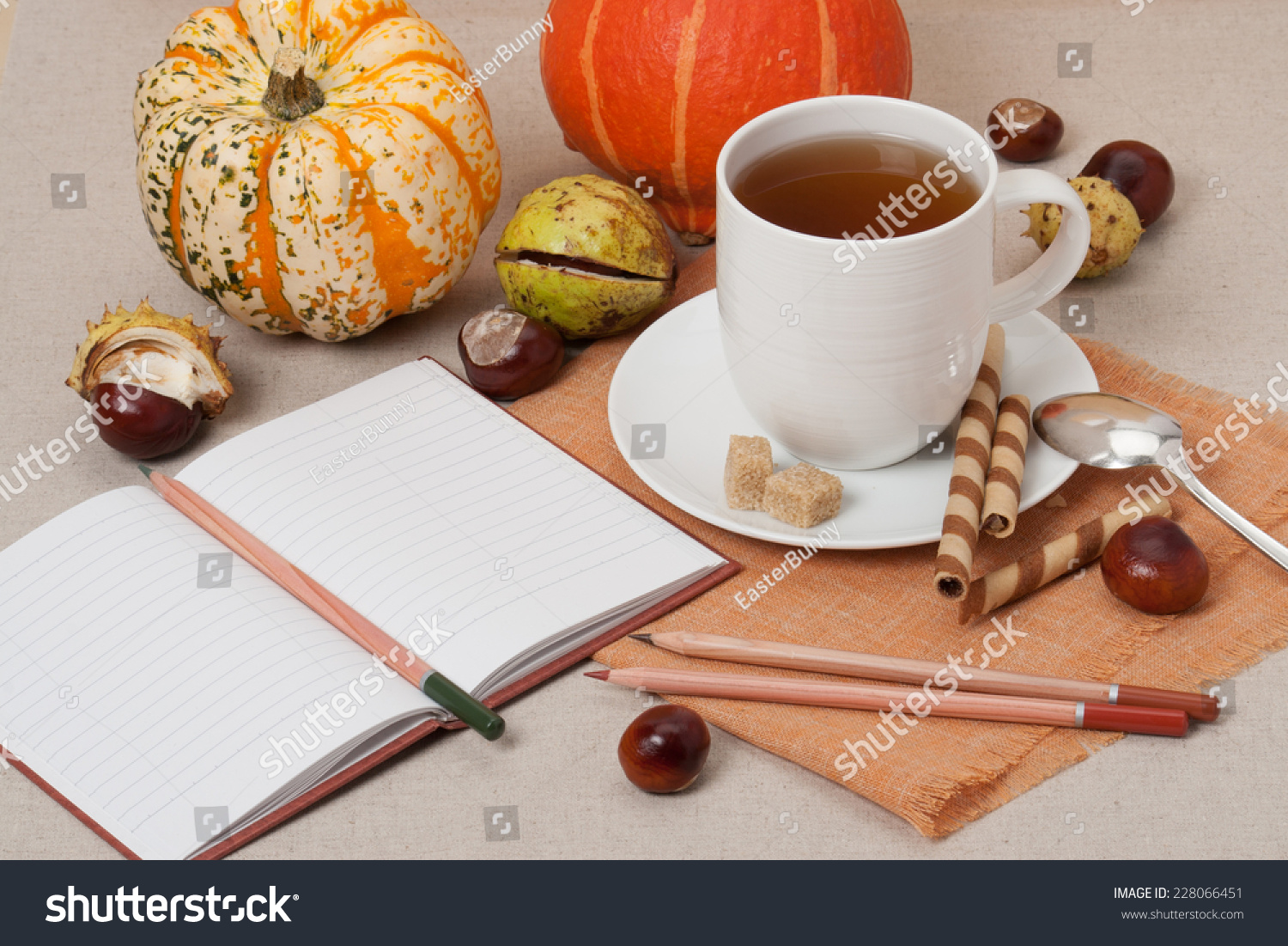opened notebook. cup of hot tea with sweets.