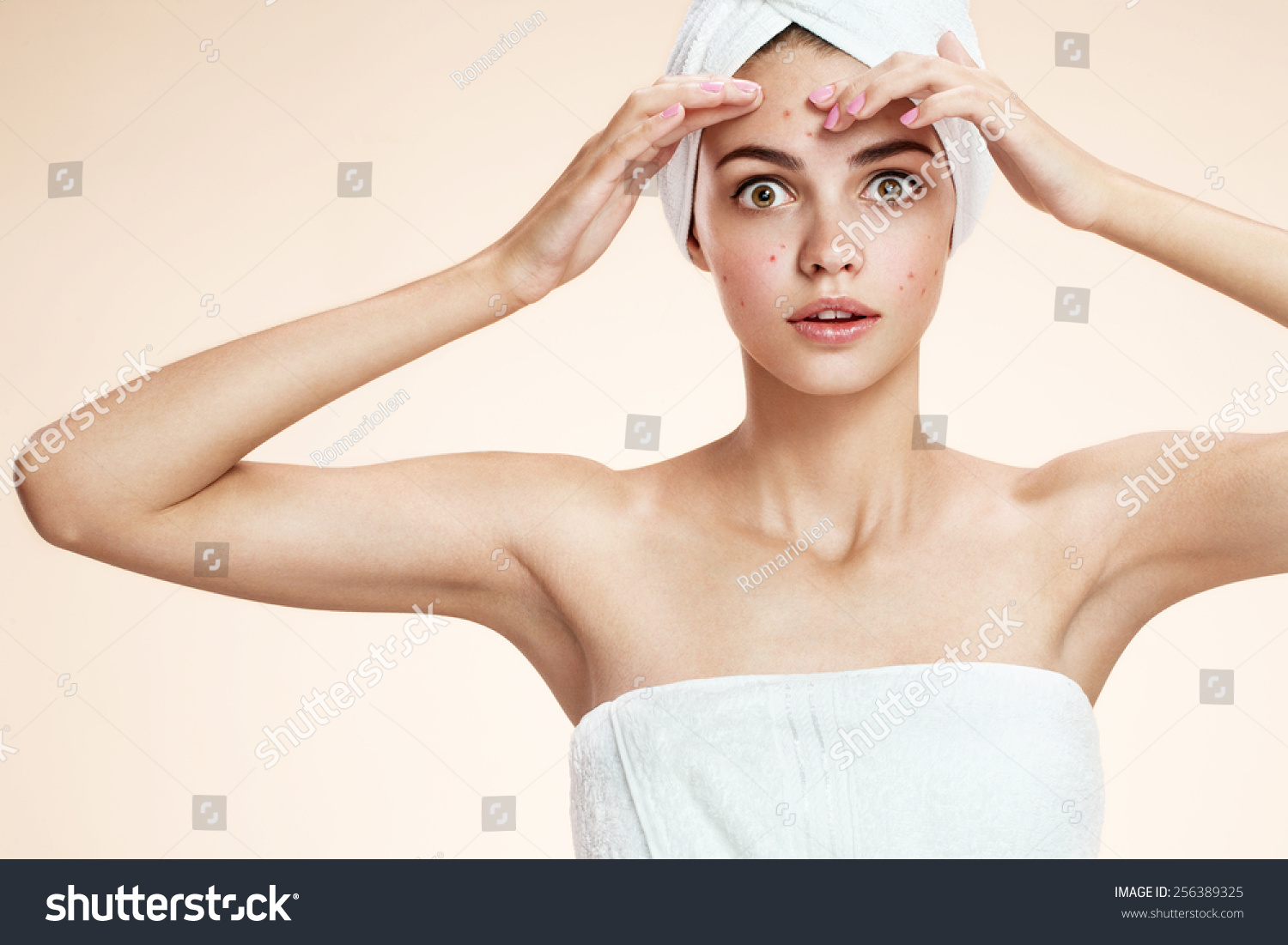 girl squeezing her pimples, removing pimple from her face.